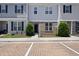 Charming townhome with gray siding, black shutters, and neat landscaping at 8885 Commons Townes Dr, Raleigh, NC 27616