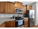 Well-equipped kitchen features modern stainless steel appliances and ample storage space in wood cabinetry at 8885 Commons Townes Dr, Raleigh, NC 27616