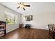 Spacious living area with wood floors, large windows, and a mounted TV for entertaining at 8885 Commons Townes Dr, Raleigh, NC 27616