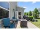 Private backyard patio with outdoor seating, barbecue grill, and well-maintained landscaping perfect for summer at 8885 Commons Townes Dr, Raleigh, NC 27616