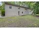 Backyard view of a brick home with a patio area and lush trees at 914 Cindy St, Cary, NC 27511