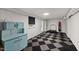 Finished basement boasts unique checkerboard flooring, gym equipment, and built-in shelving at 914 Cindy St, Cary, NC 27511
