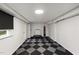 Finished basement features checkerboard flooring, a mini trampoline, and workout equipment at 914 Cindy St, Cary, NC 27511