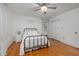 Bright bedroom with hardwood floors, a ceiling fan, and ample closet space at 914 Cindy St, Cary, NC 27511