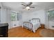 Cozy bedroom with hardwood floors, ceiling fan, and sheer curtains offering natural light at 914 Cindy St, Cary, NC 27511