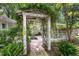 Vine-covered pergola at entrance with hanging planters and stone pathway at 914 Cindy St, Cary, NC 27511