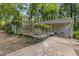 Side exterior of home with lush greenery and shaded carport at 914 Cindy St, Cary, NC 27511
