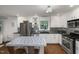 Bright kitchen with stainless steel appliances, gray countertops, and updated lighting fixtures at 914 Cindy St, Cary, NC 27511