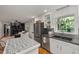 Open concept kitchen with stainless steel refrigerator and a view into the living room at 914 Cindy St, Cary, NC 27511
