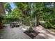 Outdoor patio featuring a table with seating surrounded by lush landscaping at 914 Cindy St, Cary, NC 27511