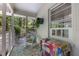 Cozy screened porch with a rocking chair and colorful accents at 914 Cindy St, Cary, NC 27511