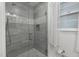 Modern bathroom featuring stylish glass enclosed shower, neutral tile, and mosaic accents at 914 Cindy St, Cary, NC 27511