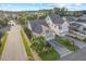Aerial view of the charming home with a well-manicured lawn, spacious driveway, and garage at 997 Windy Rd, Apex, NC 27502