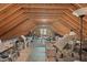 Spacious attic featuring exposed beams, workout equipment, and natural light at 997 Windy Rd, Apex, NC 27502