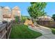 Landscaped backyard featuring lush green grass, a patio, and privacy fence at 997 Windy Rd, Apex, NC 27502