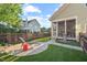 Backyard with lawn and patio, separated by wooden fence from other homes at 997 Windy Rd, Apex, NC 27502