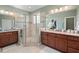 Spacious bathroom with double vanity, tiled shower, and a walk-in closet at 997 Windy Rd, Apex, NC 27502