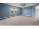 Bedroom with blue walls, a ceiling fan, carpet, and natural light at 997 Windy Rd, Apex, NC 27502