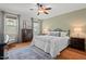 Bedroom with a ceiling fan, a large bed, natural light, hardwood floors and bedside tables at 997 Windy Rd, Apex, NC 27502