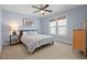 Bedroom with blue walls, a ceiling fan, and natural light at 997 Windy Rd, Apex, NC 27502