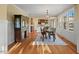 Elegant dining area with natural light, hardwood floors, and modern chandelier at 997 Windy Rd, Apex, NC 27502