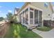Exterior view of a screened porch overlooking a well-maintained lawn and landscaping at 997 Windy Rd, Apex, NC 27502