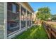 Charming screened porch, perfect for relaxing, overlooks the lush backyard and nearby houses at 997 Windy Rd, Apex, NC 27502