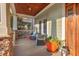 Cozy covered front porch with comfortable seating and elegant decorative accents at 997 Windy Rd, Apex, NC 27502