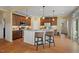 Well-equipped kitchen with an island, granite countertops, stainless steel appliances, and hardwood floors at 997 Windy Rd, Apex, NC 27502