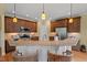 Spacious kitchen featuring an island with seating, granite countertops, and stainless steel appliances at 997 Windy Rd, Apex, NC 27502
