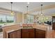 Open kitchen area with granite countertops and an island that flows to the backyard at 997 Windy Rd, Apex, NC 27502