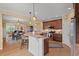 Open-concept kitchen with island seating, granite countertops, stainless steel appliances, and hardwood floors at 997 Windy Rd, Apex, NC 27502
