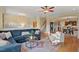 Open-concept living room featuring hardwood floors, a large sectional, and elegant decor at 997 Windy Rd, Apex, NC 27502