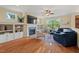Inviting living room with a fireplace, built-in shelves, and ample natural light at 997 Windy Rd, Apex, NC 27502