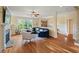Bright living room features a cozy fireplace, hardwood floors, and large windows at 997 Windy Rd, Apex, NC 27502