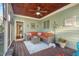 Inviting screened porch boasts outdoor seating, a ceiling fan, and stylish decor at 997 Windy Rd, Apex, NC 27502