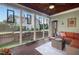 Inviting screened porch with outdoor furniture offering views of the fenced backyard at 997 Windy Rd, Apex, NC 27502
