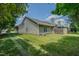 Well-maintained backyard featuring a lush green lawn, privacy fence, and mature trees at 101 Kingston Ln, Graham, NC 27253