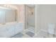 Bright bathroom with double sink vanity and tiled shower at 101 Kingston Ln, Graham, NC 27253