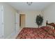 Bedroom with adjacent doorways and a faux-tree at 101 Kingston Ln, Graham, NC 27253