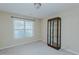 Bright bedroom featuring a window with blinds and a glass shelved cabinet at 101 Kingston Ln, Graham, NC 27253