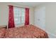 Bedroom with a window with red curtains and a closet at 101 Kingston Ln, Graham, NC 27253