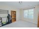 Bedroom features a window, carpet, bookcase, and golf clubs at 101 Kingston Ln, Graham, NC 27253