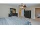 Bedroom features a ceiling fan, carpeted floor, closet access, and an adjoining bathroom at 101 Kingston Ln, Graham, NC 27253
