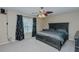Primary bedroom with a ceiling fan, window, neutral walls, carpet, and a large bed at 101 Kingston Ln, Graham, NC 27253