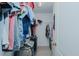 Walk-in closet with wire shelving and hanging clothes at 101 Kingston Ln, Graham, NC 27253