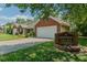 View of the townhomes in Kingston Village with brick accents and manicured landscaping at 101 Kingston Ln, Graham, NC 27253