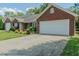 Single-story brick home boasting a two car garage, manicured lawn, and inviting curb appeal at 101 Kingston Ln, Graham, NC 27253