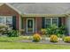 Inviting front entrance features a glass door, brick facade, and professional landscaping at 101 Kingston Ln, Graham, NC 27253