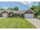 Charming brick and siding home with a well-maintained lawn and attached one car garage at 101 Kingston Ln, Graham, NC 27253